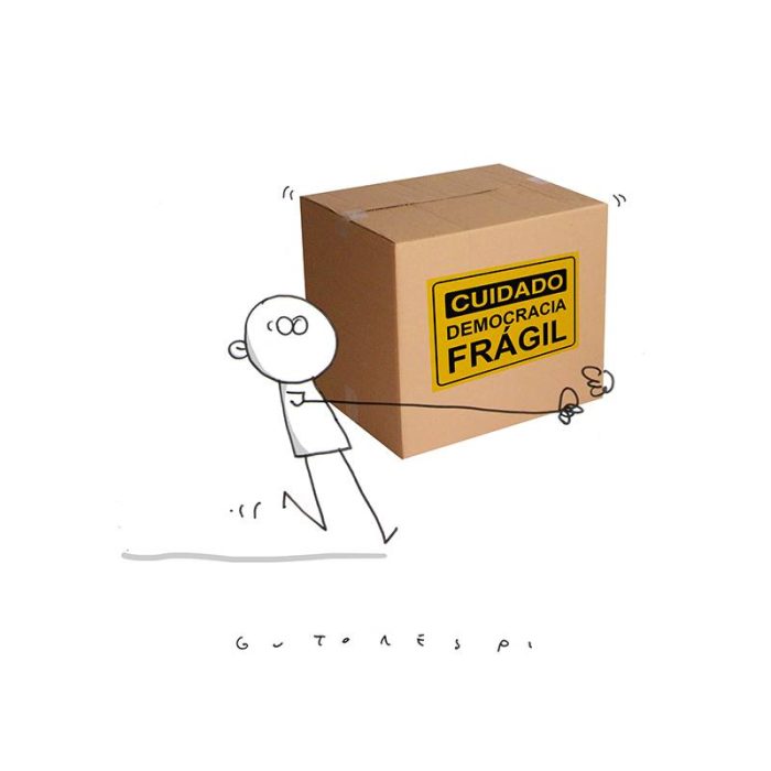 Desenho de homem carregando caixa em que está escrito: "Cuidado democracia FRÁGIL"