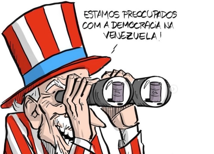 Charge do Nando Motta sobre a invasão dos EUA na Venezuela. A desculpa é a democracia, o objetivo real é o petróleo, assim como foi com a invasão do Iraque em 2003.